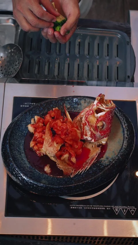 4K vertical video chef selecting final garnish for plated dish Stock Footage 315395574