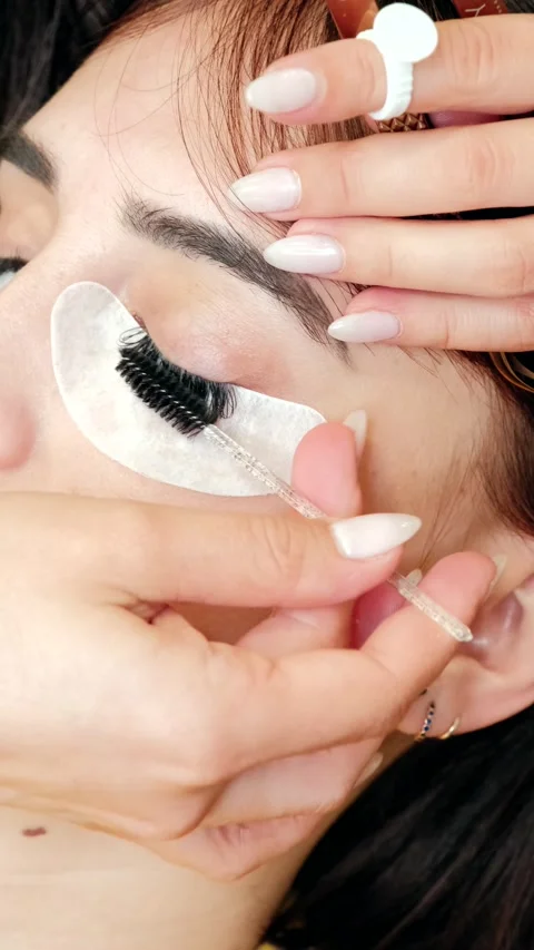 4k vertical video of extension lashes comb and roll Stock Footage 272234343