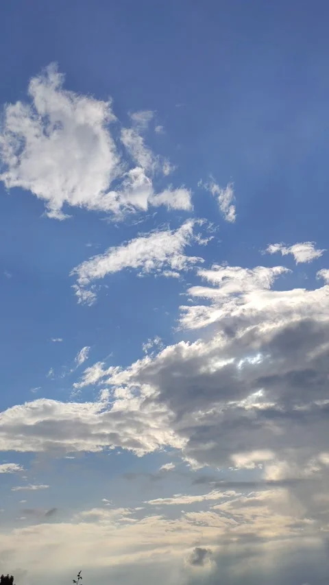 4k vertical video of an intense blue sky with moving clouds Stock Footage 198405035