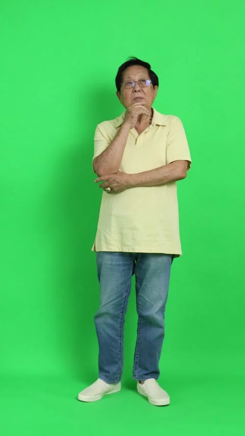 4K vertical video of a senior Asian man touching his chin and looking up left an Stock Footage 342777480