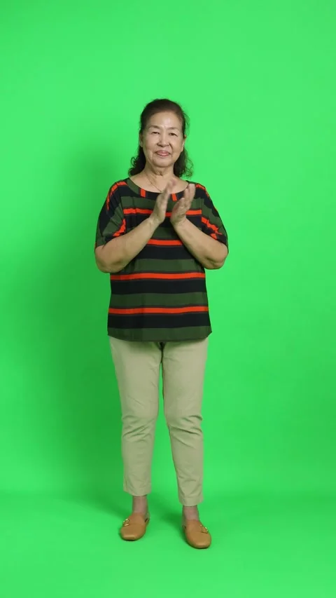 4K vertical video of a senior Asian woman clapping her hands with a joyful and a Stock Footage 342777526