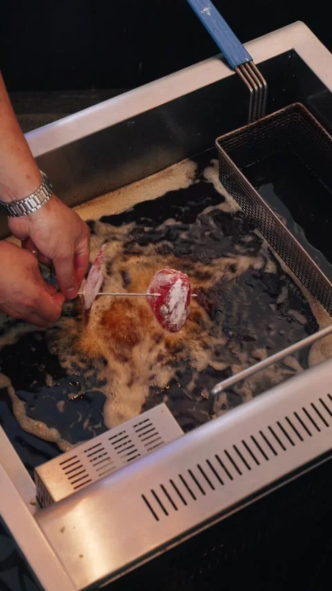 4K vertical video snapper frying in deep fryer – overhead shot Stock Footage 315395488