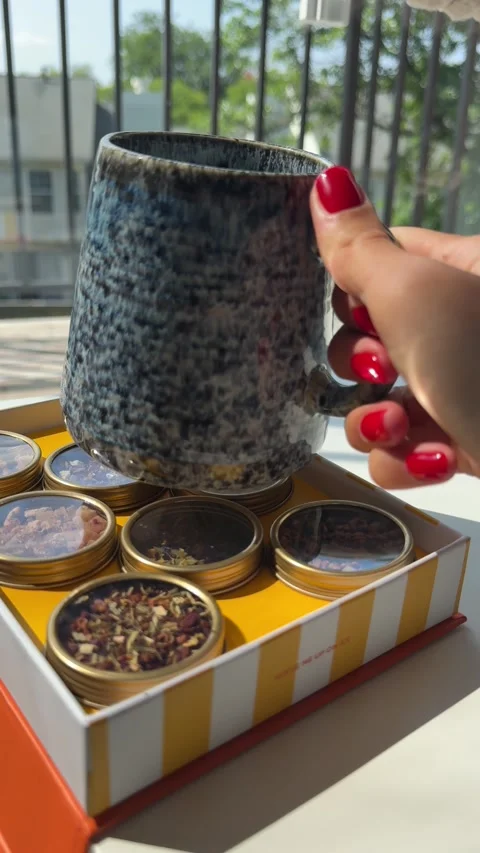 4K vertical video of a woman's hand picking up a cup of freshly brewed tea Stock Footage 342071854