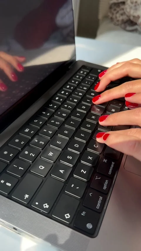4K vertical video of a woman's hands with manicure typing on a laptop keyboard Stock Footage 342063932