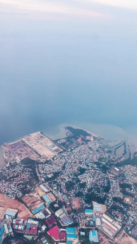 4K vertical view of Batam Island and ocean as seen from moving airplane window.  Video stock 339784982