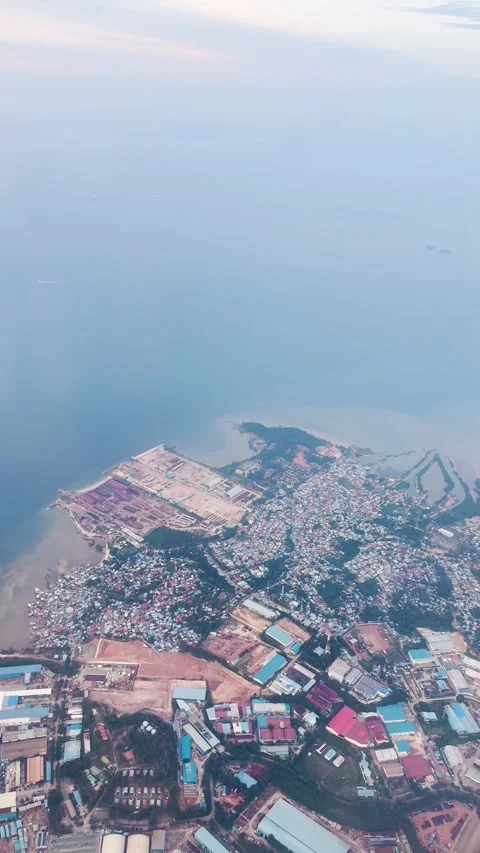 4K vertical view of Batam Island and ocean as seen from moving airplane window.  Video stock 339785061