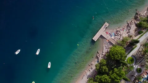 4k vertical view of the sea coast with beach with drifting boats near the pier Stock Footage 201413761