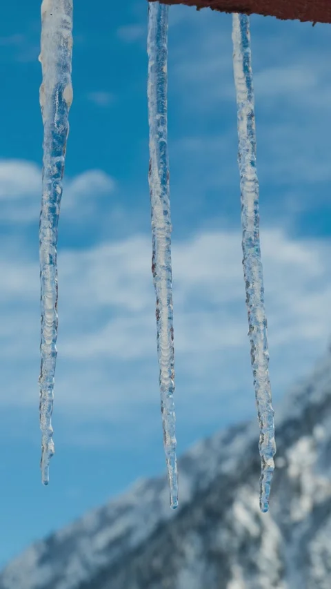 4k verticle timelapse of melting icicles hanging from roof Video stock 327826955