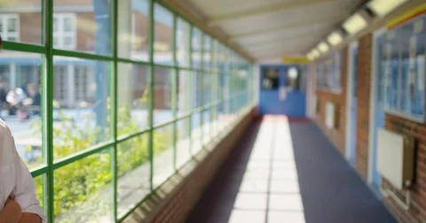 4K Very sad school boy standing alone in school hallway Stock Footage 76963414