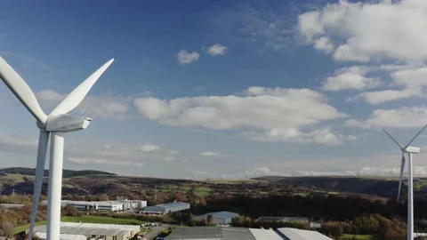 4k video of 2 wind turbines stationary on welsh valley background. blue sky Video stock 142595327