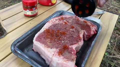 4K video of applying spices meat before grilled Stock-Footage 213516408