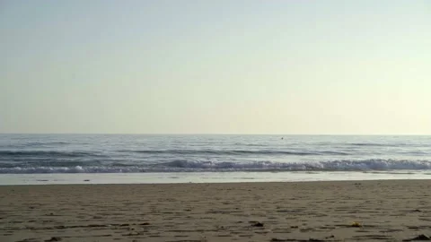 4k video of a beach at sunset with the waves breaking on the shore. Concept o Stock Footage 135728148