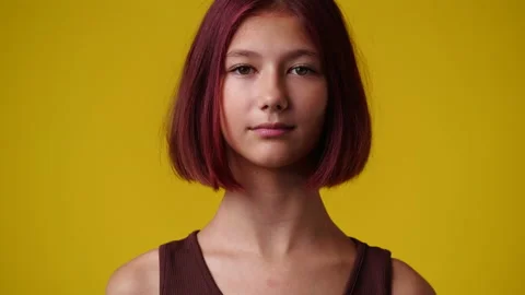 4k video of blank emotion of one girl on yellow background. Stock Footage 223510079