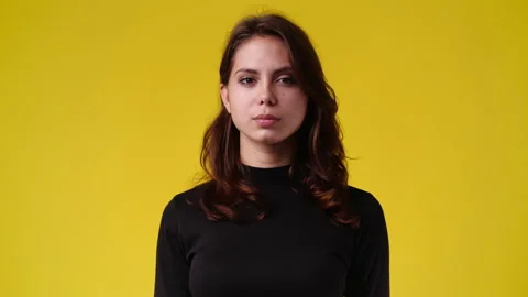4k video of blank emotion of one girl on yellow background. Stock Footage 229673849