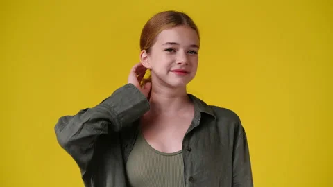 4k video of blank emotion of one girl on yellow background. Stock Footage 233010891