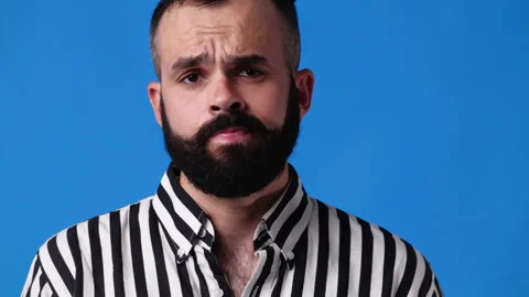 4k video of blank emotion of one man on blue background. Video stock 235241063