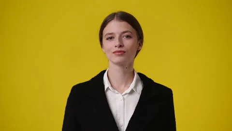 4k video of blank emotion of one girl on yellow background. Stock Footage 237534103