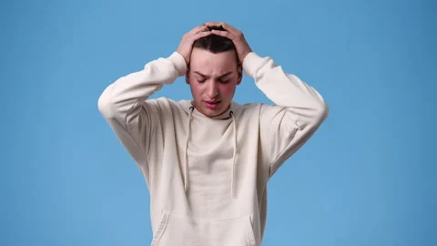 4k video of blank emotion of one man on blue background. Stock Footage 237636058