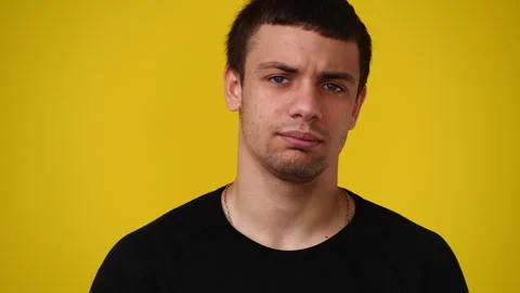 4k video of blank emotion of one man on yellow background. Stock Footage 243634112