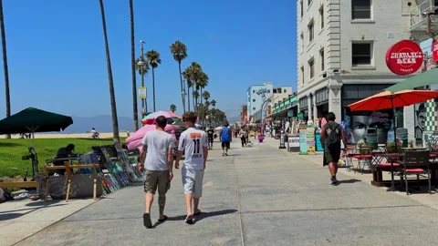 4K Video of Bustling Venice Beach Promenade with Shops and Caricature Stands Stock Footage 325166812