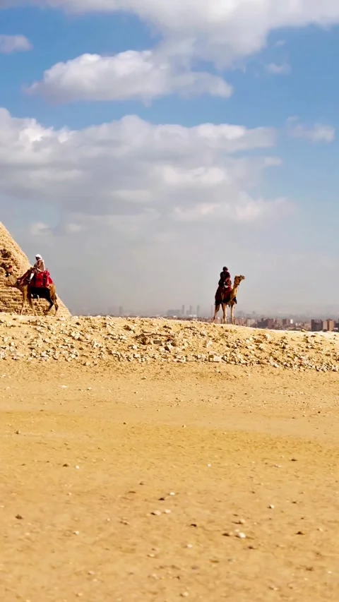 4K video of a camel riders in the desert near the Pyramids of Giza Stock Footage 335030402