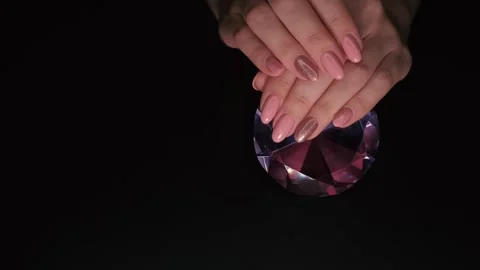 This 4K video captures a close-up of a pink manicure with sparkles. Stock Footage 252766814