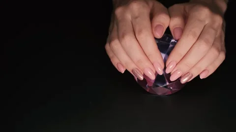 This 4K video captures a close-up of a pink manicure with sparkles. Stock Footage 253432350