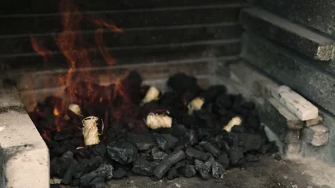 4K video of a Caucasian hands placing rolls on a barbecue charcoal fires Stock Footage 219967700