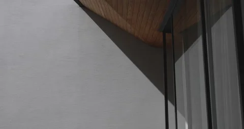 4K video cement clean wall with movement natural shadow with wooden ceiling. Stock Footage 212043845