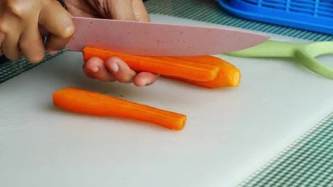 4k video clean the carrot bones and cut the carrots on a board. Stock-Footage 294195889