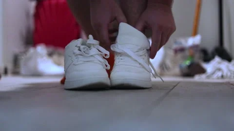 4K video close up. 60 fps. Man ties sport sneakers before going for fitness Video stock 337831943