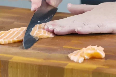 4k video Close up of Chef cook hands chopping salmon fish for sushi Stock Footage 152847307