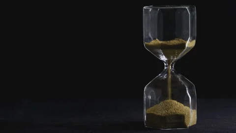 4K video Close up of falling sand in sand clock on black background. Concept  Stock Footage 155135921