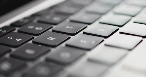 4K Video close up light moving on keyboard notebook. Concept for coding and t Stock Footage 169322692