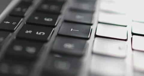 4K Video close up light moving on keyboard notebook. Concept for coding and t Stock Footage 169322749