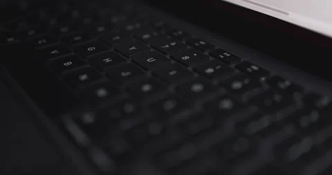 4K Video close up light moving on keyboard notebook. Concept for coding and t Stock Footage 169322843