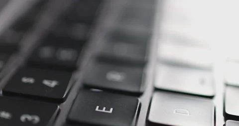 4K Video close up light moving on keyboard notebook. Concept for coding and t Stock Footage 170914206