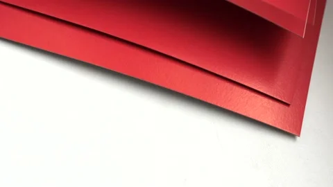 4k video, close-up of red paper sheets, laid out on a white background, top view Stock Footage 180326509