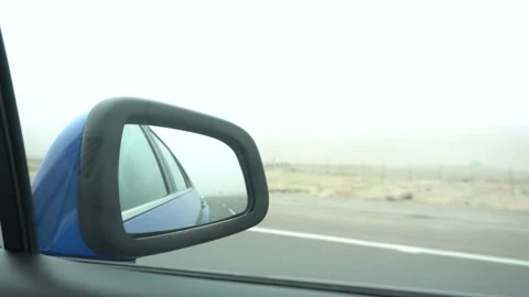 4k video of a close-up of the side rear view mirror of a moving car  Video stock 144357381