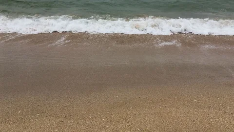 4k video Close up view of sand and sea waves crushing or splashing on the beach Stock Footage 115070022