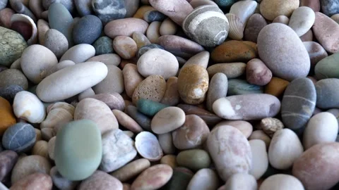 4K video of colored smooth pebbles and seashells rotation closeup Stock Footage 241306256