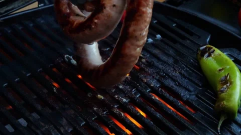 4K video cooking on grill sausage, twisted spiral, slow motion closeup, outdoors Stock Footage 245021953