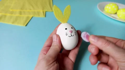 4k video Creative Easter spring egg with bunny ears and cute pink paws on a blue 스톡 동영상 236416264