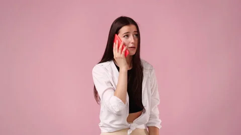 4k video of cute woman using phone isolated over pink background. Stock Footage 218326883