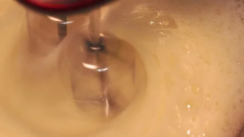 4k video detail beating egg white with an electric mixer. Stock Footage 262655424