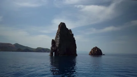 4K video of dramatic rocky sea stacks off the Sicilian coast, Italy. Clear .. Stock Footage 335109109