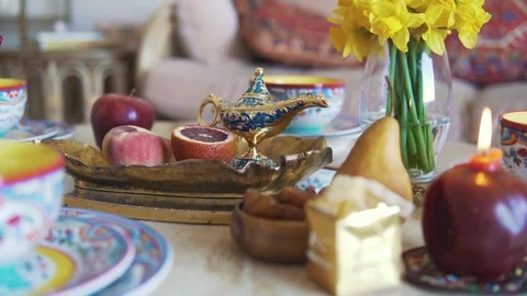 4K Video Eid Holiday Table Setting with Lamp Dates Fruit and Daffodils Video stock 330422615