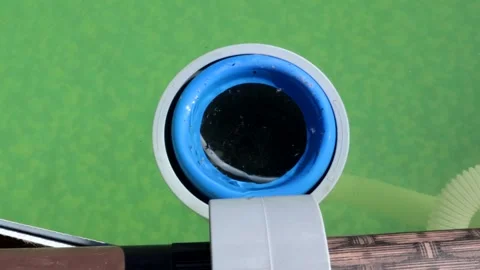 4k video, filter purifies water in an outdoor frame country pool from insects Stock Footage 253615593