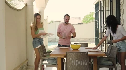 4K video of friends preparing the table for lunch Stock Footage 219967732