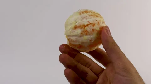 4K video of a hand holding a fully peeled orange. High detail on the surface Video stock 308922808